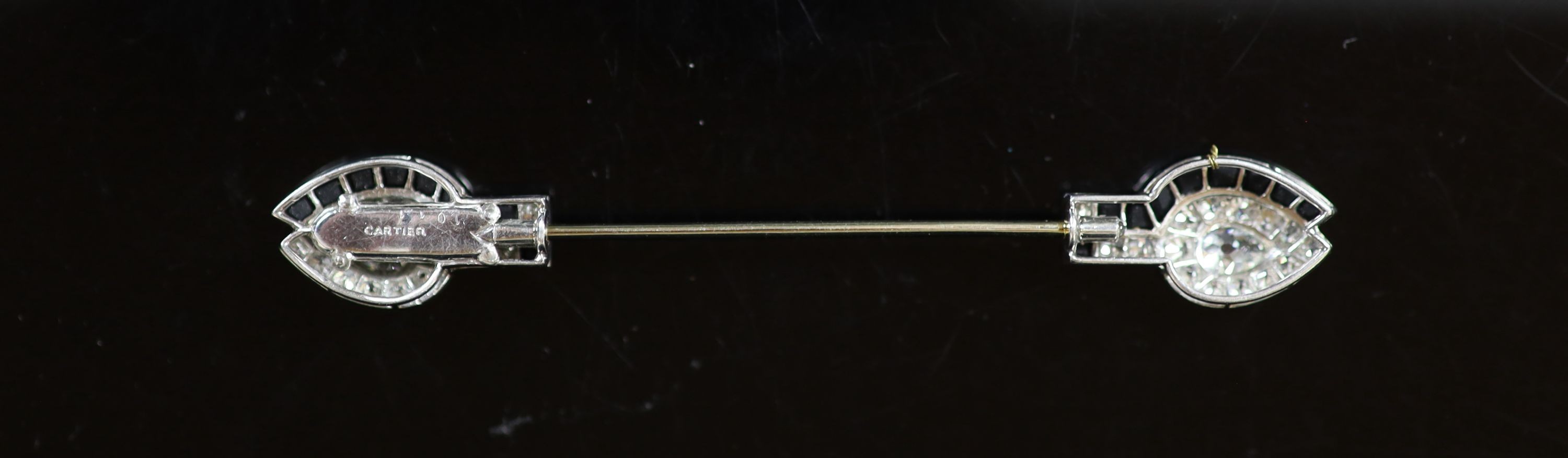 A 1930's/1940's Cartier platinum, diamond and black onyx set jabot pin
